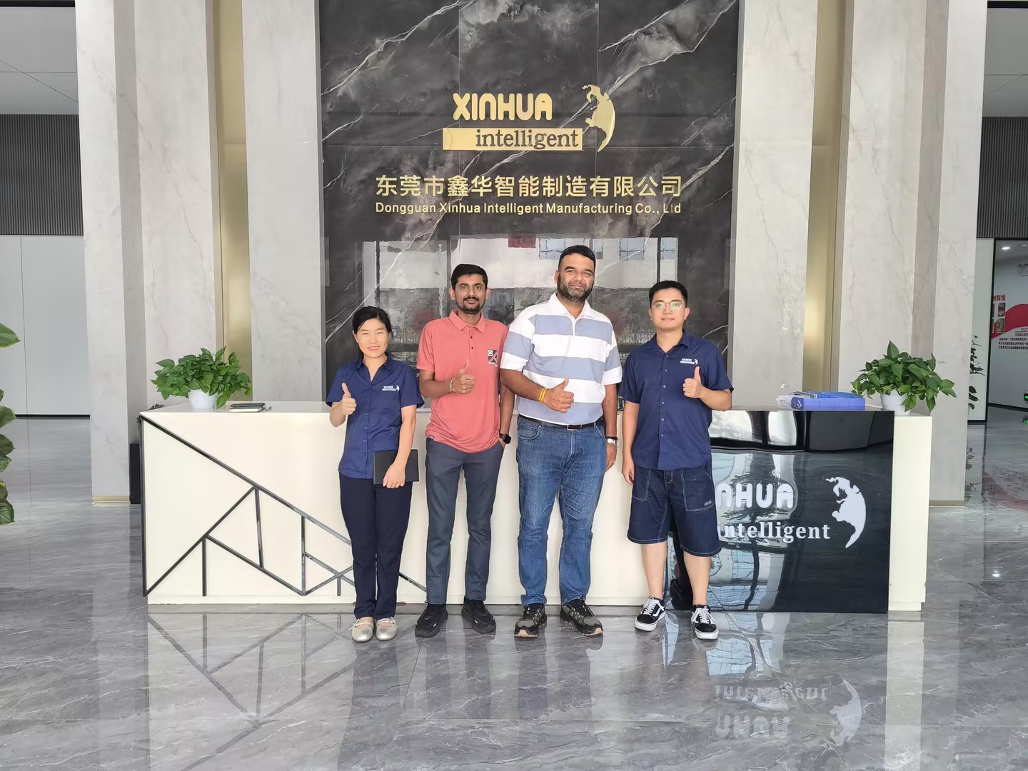 Two foreign trade salespersons from Xinhua Intelligent took a commemorative photo with the Indian guests.